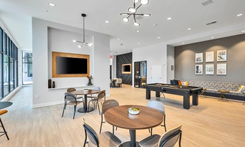 large, wall mounted tvs in bright clubhouse