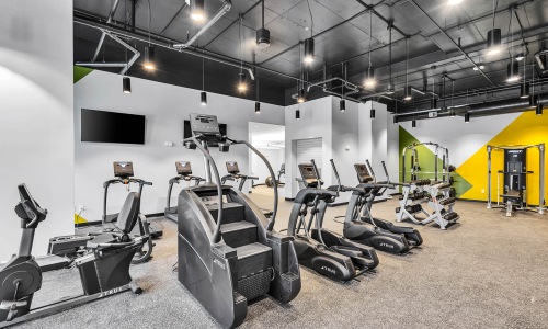 well equipped gym with ample lighting throughout